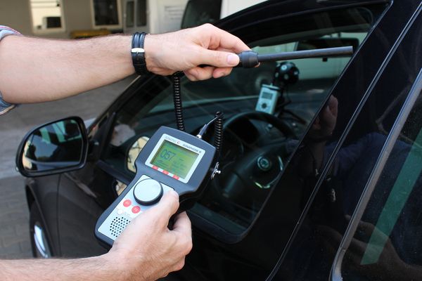 [Translate to Deutsch:] Ultrasonic tightness testing at a car with ultrasonic testing device and sensor
